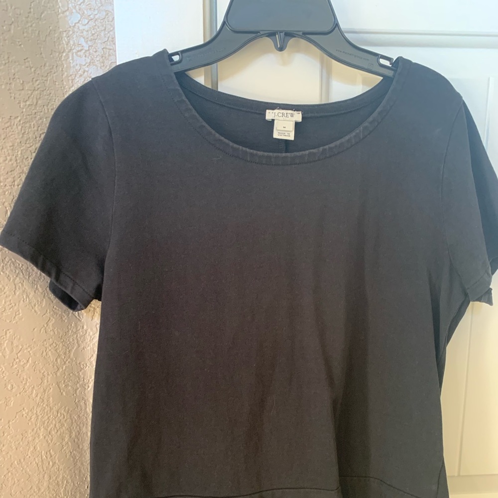 J Crew medium black top with ruffled hem.